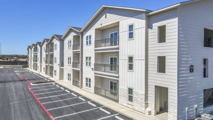 Boerne Apartments - Garden Creek - Exterior View of Apartment Building and Balconies Facing the Parking Lot.