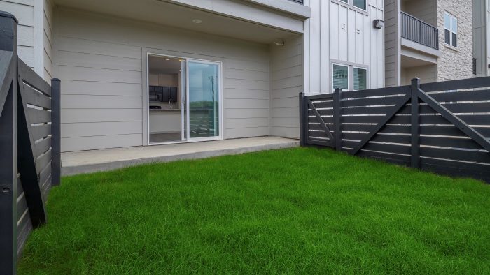 Boerne, TX Apartments - Garden Creek - Apartment Patio/Backyard with Concrete space and Grass Area.
