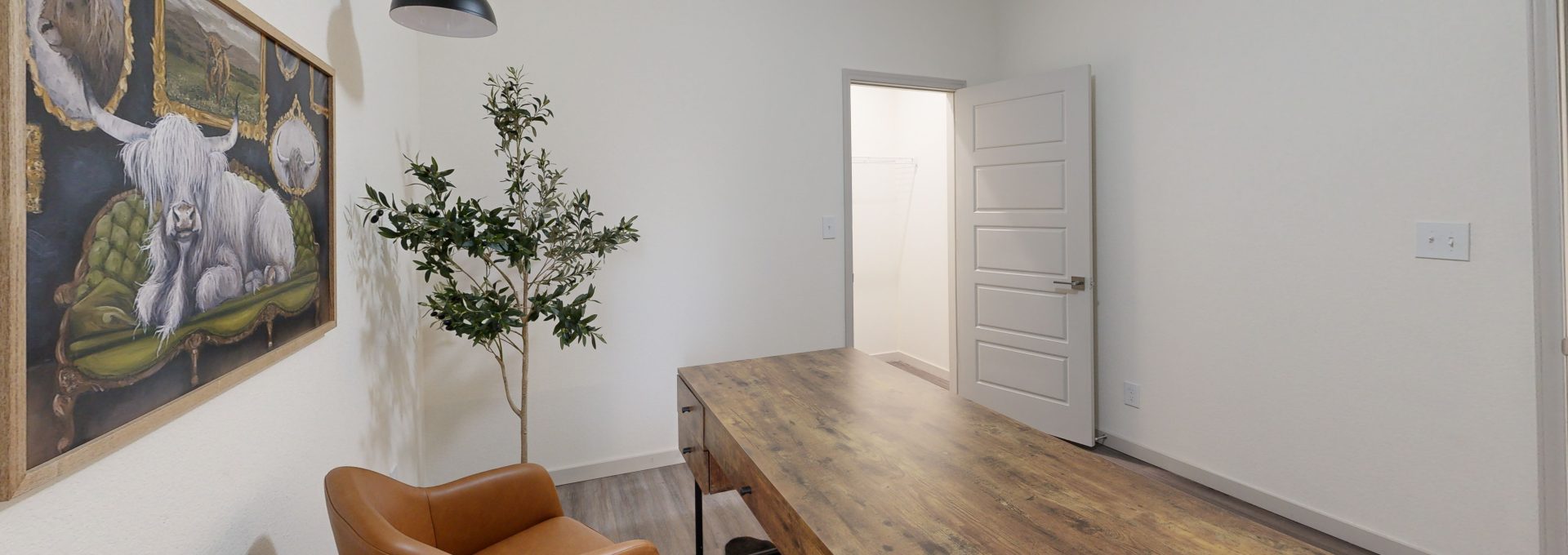 a room with a desk and chair in it at The Garden Creek Apartments