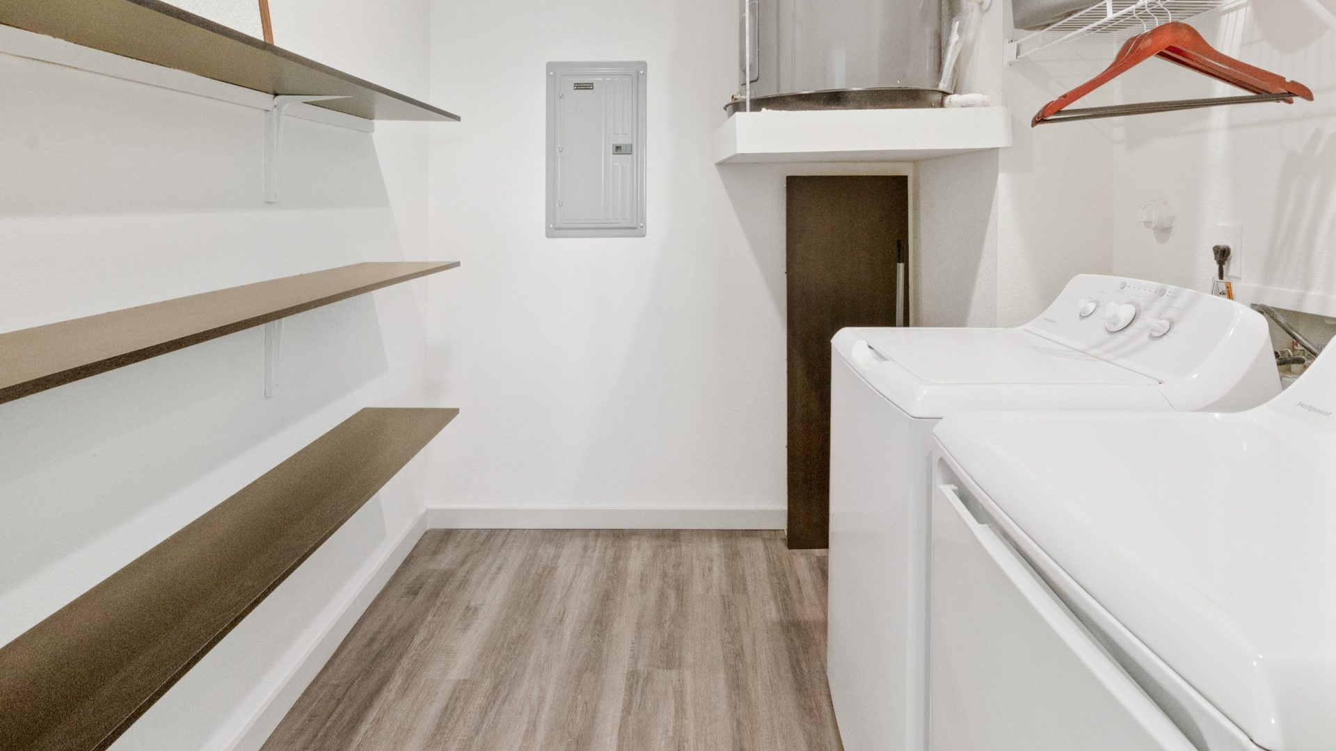 a laundry room with a washer and dryer at The Garden Creek Apartments