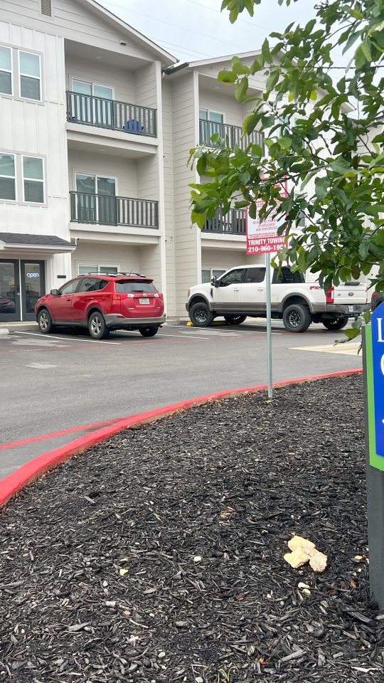 a sign for the leasing center at The Garden Creek Apartments
