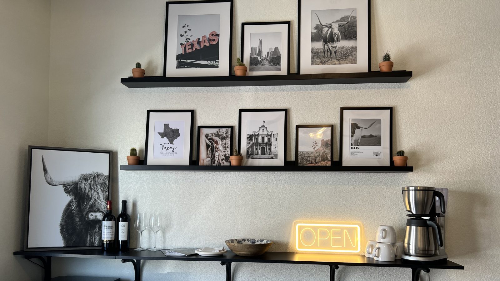 a shelf with pictures and a lamp on it at The Garden Creek Apartments